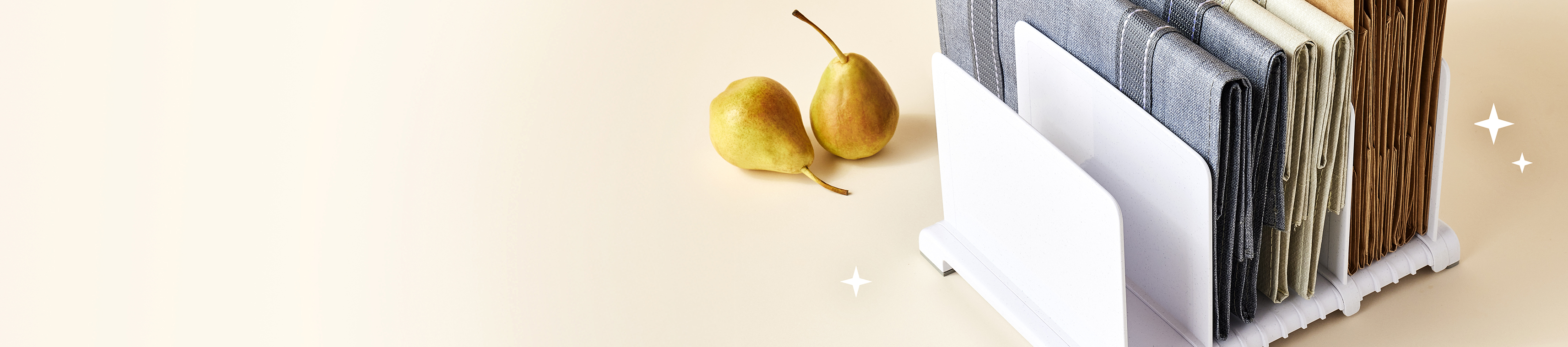 Reusable bag organizer displaying various bags with a couple of pears on a light background.