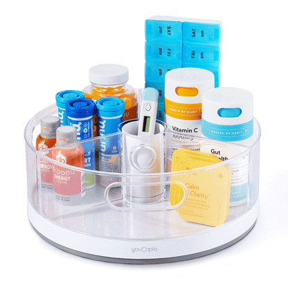 Turntable organizer with various supplements and containers on a white background